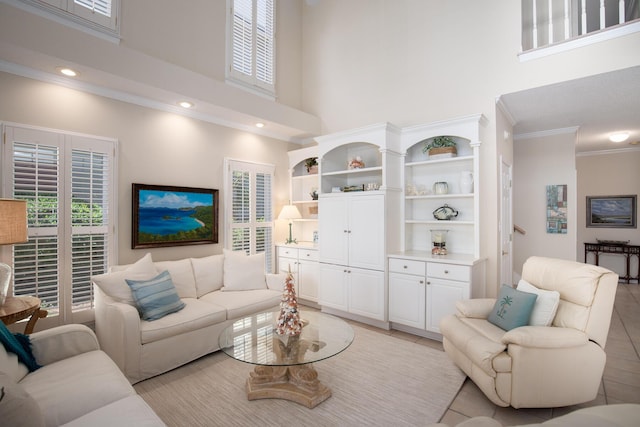 living room featuring light tile patterned floors, crown molding, and a high ceiling