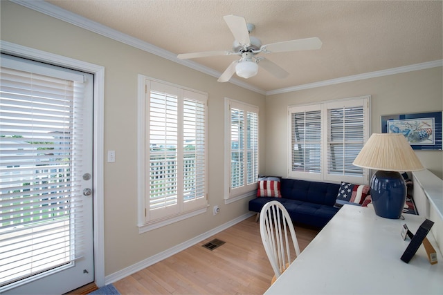 office space featuring hardwood / wood-style floors, a textured ceiling, ceiling fan, and crown molding