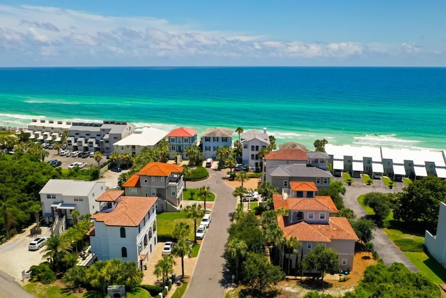 drone / aerial view featuring a water view and a beach view