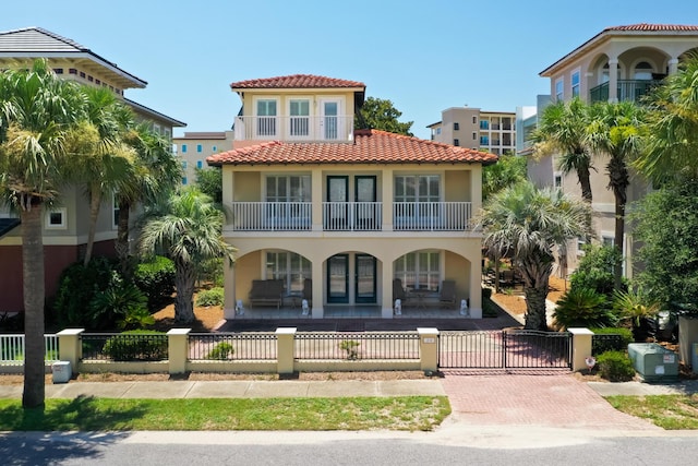 mediterranean / spanish home featuring covered porch and a balcony