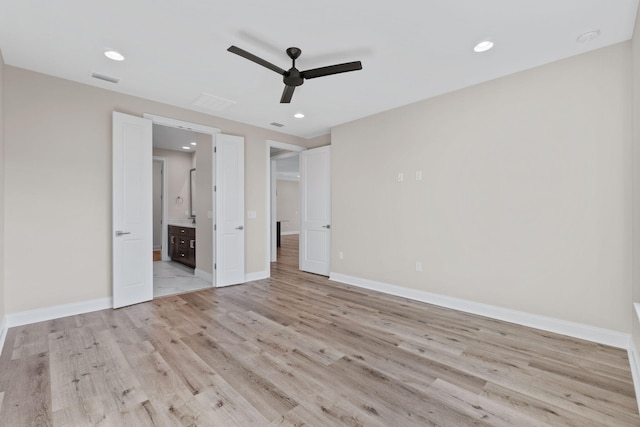 unfurnished bedroom with ceiling fan, light wood-type flooring, and ensuite bathroom