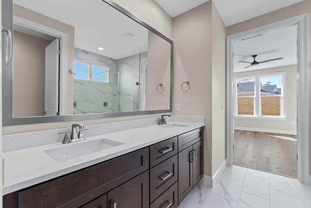 bathroom featuring ceiling fan, a healthy amount of sunlight, a shower with shower door, and vanity