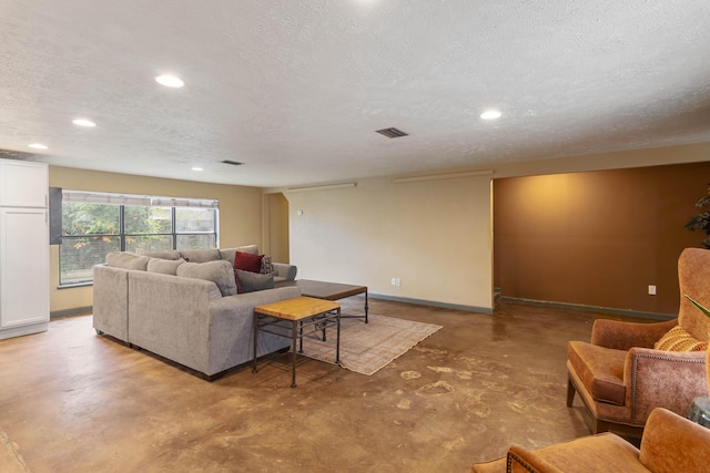 living area featuring visible vents, baseboards, finished concrete floors, a textured ceiling, and recessed lighting