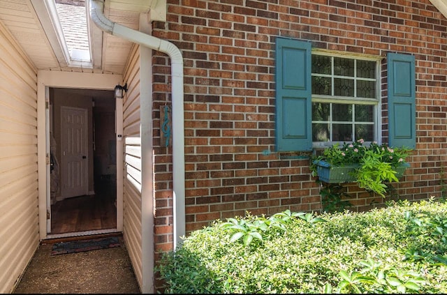 property entrance featuring brick siding