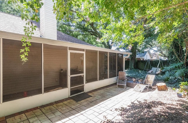 view of patio featuring a sunroom