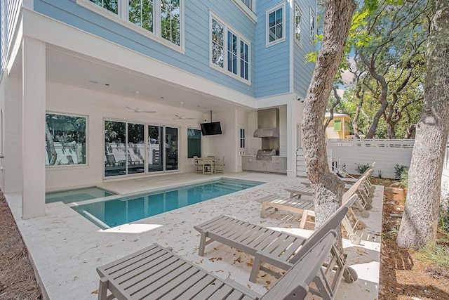 view of pool featuring a grill, ceiling fan, a patio, and an outdoor kitchen