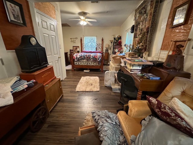 bedroom with dark hardwood / wood-style flooring and ceiling fan