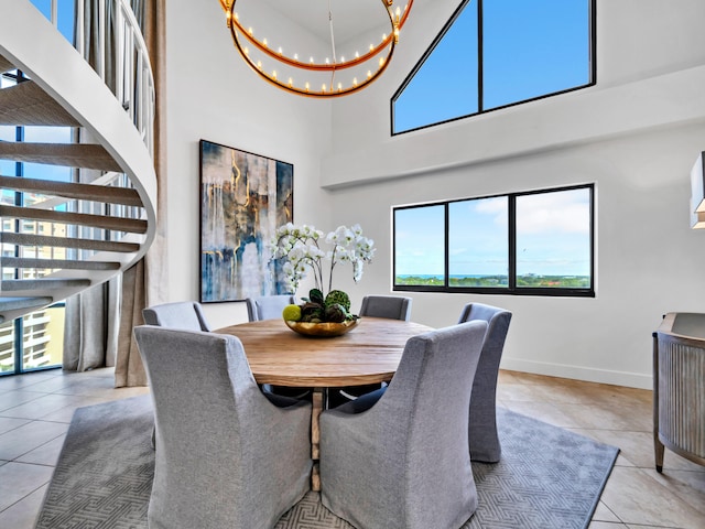 dining area with light tile patterned flooring and a chandelier