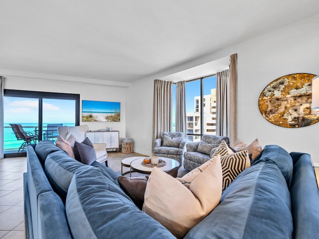 living room featuring a water view, radiator heating unit, and light tile patterned floors