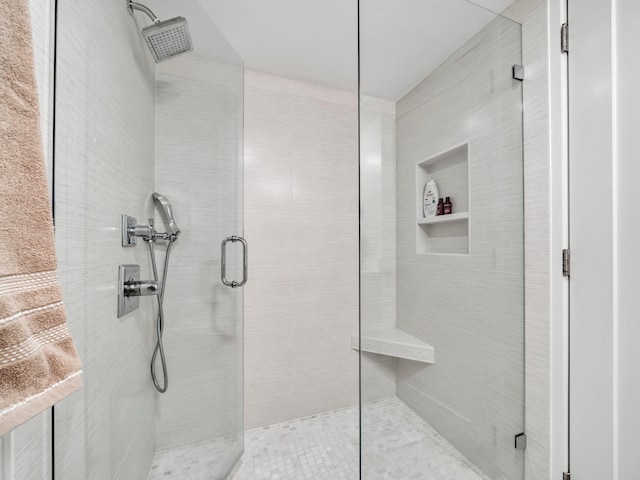 bathroom with a shower with door