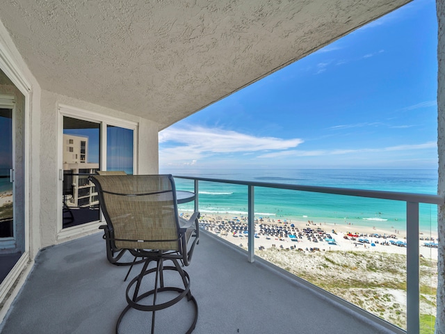 balcony with a view of the beach and a water view