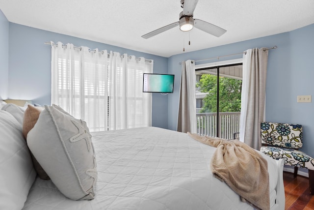 bedroom featuring access to outside, ceiling fan, wood-type flooring, and a textured ceiling