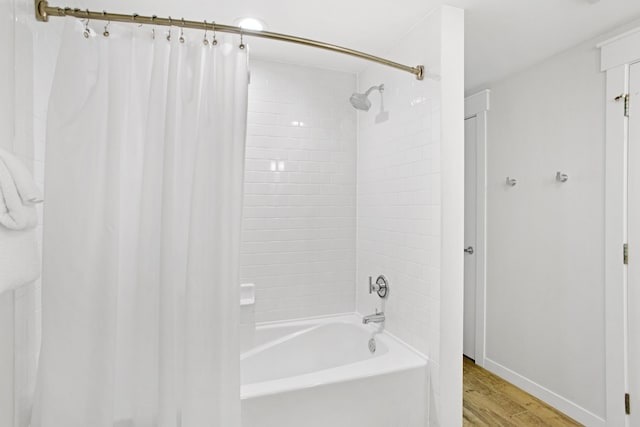 bathroom featuring hardwood / wood-style floors and shower / bath combination with curtain