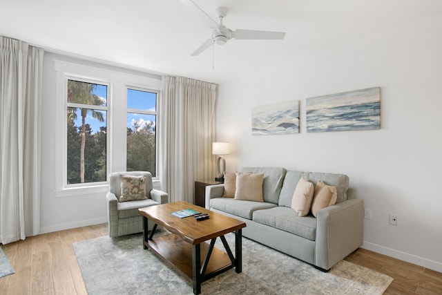 living room featuring ceiling fan and light wood-type flooring