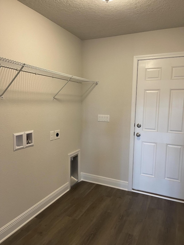 washroom featuring washer hookup, electric dryer hookup, dark hardwood / wood-style floors, and a textured ceiling