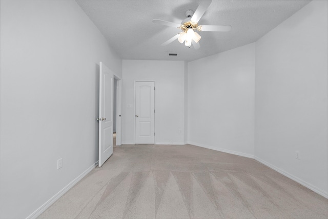 carpeted empty room featuring a textured ceiling and ceiling fan