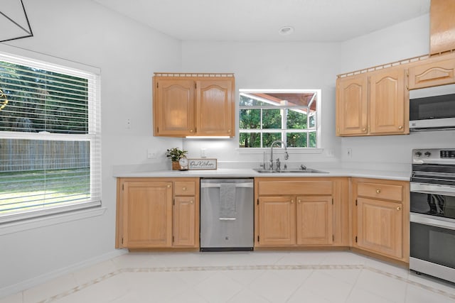 kitchen featuring stainless steel appliances, sink, light tile patterned floors, and light brown cabinets