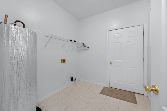 laundry area featuring hookup for a washing machine and light tile patterned floors