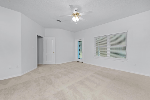 carpeted empty room featuring ceiling fan and a textured ceiling