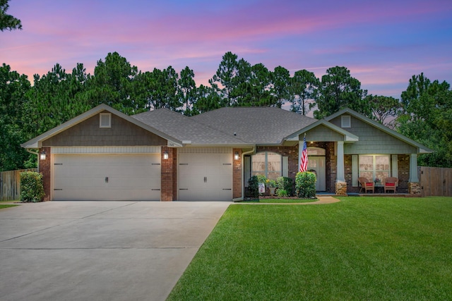 craftsman-style home featuring a yard and a garage