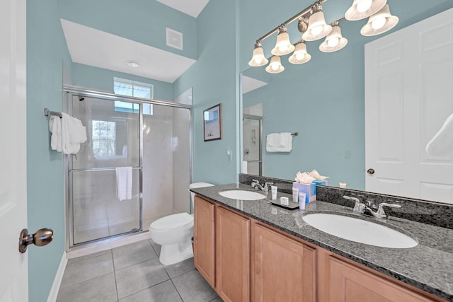 bathroom featuring tile patterned floors, toilet, vanity, and walk in shower