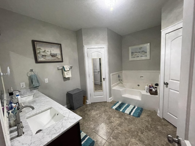 bathroom featuring vanity and a bath