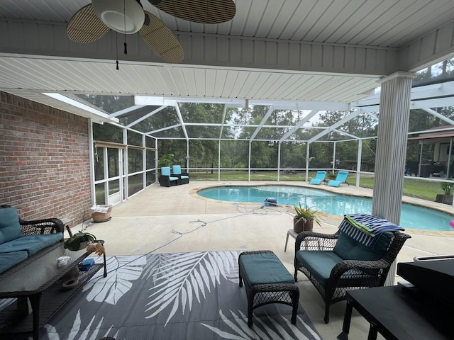 view of swimming pool with an outdoor living space, a lanai, a patio, and ceiling fan