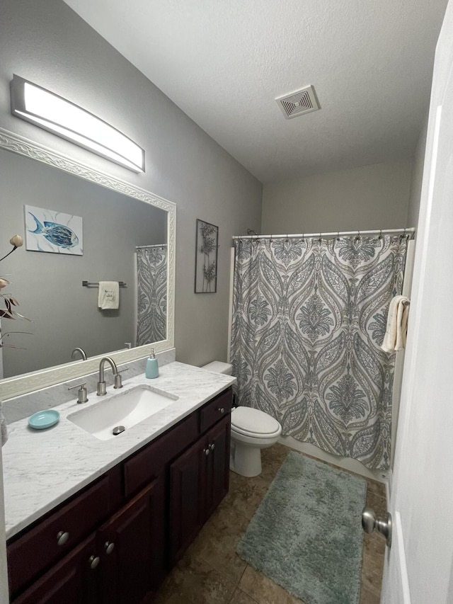 bathroom featuring vanity, toilet, curtained shower, and a textured ceiling