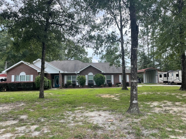 single story home featuring a carport and a front lawn