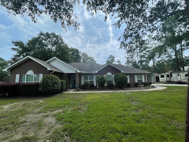 ranch-style home featuring a front yard