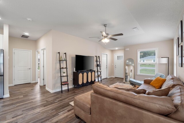 living room with ceiling fan and dark hardwood / wood-style floors