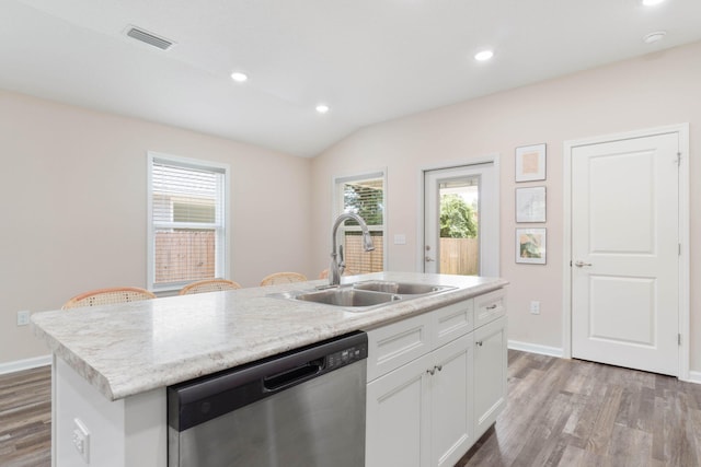 kitchen with dishwasher, wood-type flooring, sink, and an island with sink