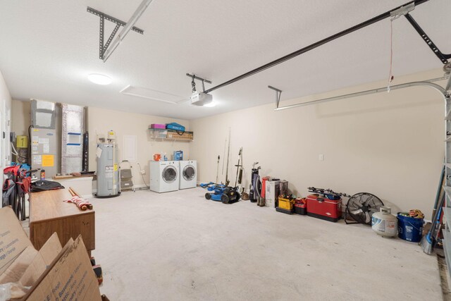 garage with washing machine and dryer and water heater