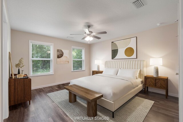 bedroom with ceiling fan and dark wood-type flooring