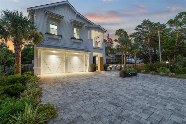 view of front of home featuring a garage and a balcony