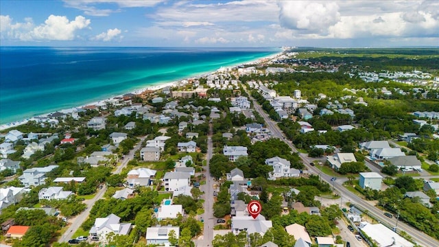 birds eye view of property with a beach view and a water view