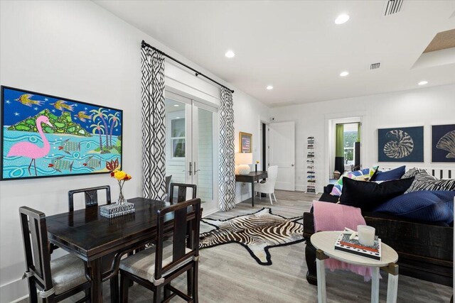 living room with french doors and light wood-type flooring