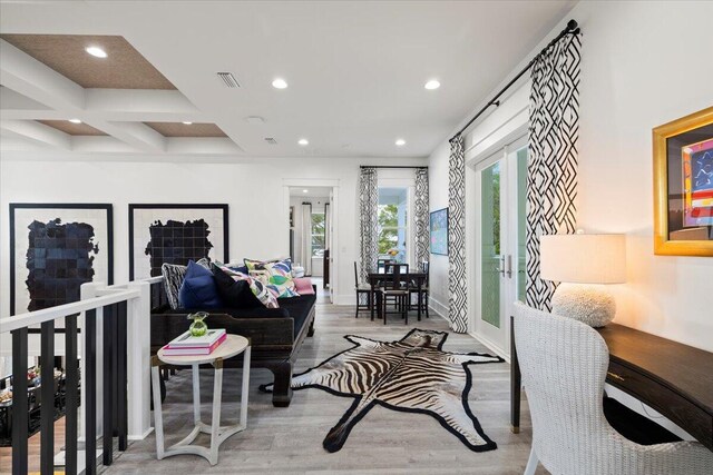 living room with hardwood / wood-style floors, coffered ceiling, and beam ceiling