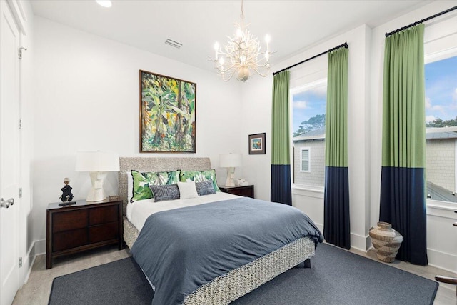 bedroom with multiple windows and a notable chandelier