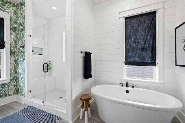 bathroom with plus walk in shower and hardwood / wood-style flooring