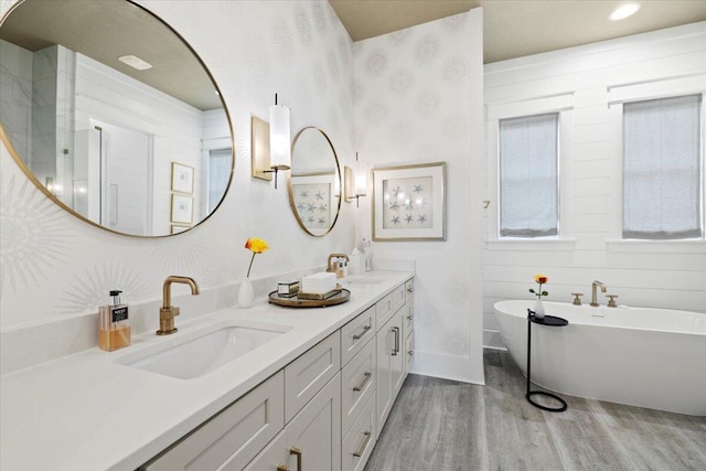 bathroom featuring a bathing tub, vanity, and hardwood / wood-style floors