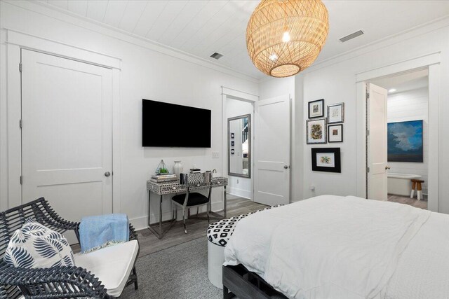 bedroom with crown molding and dark hardwood / wood-style flooring