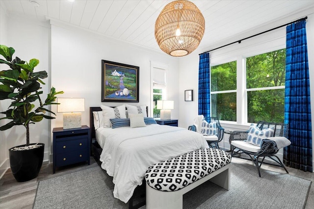 bedroom with multiple windows, wooden ceiling, and wood-type flooring