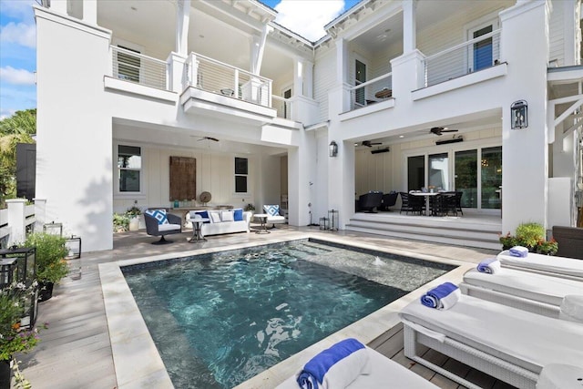 exterior space featuring outdoor lounge area, ceiling fan, and a patio