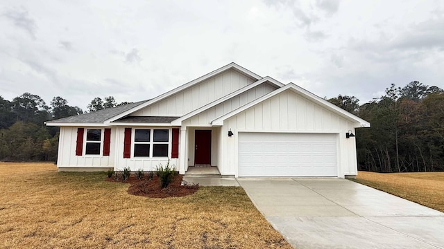 view of front of house with a garage and a front lawn