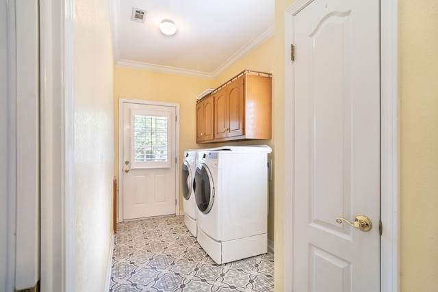 laundry area featuring separate washer and dryer, crown molding, and cabinets