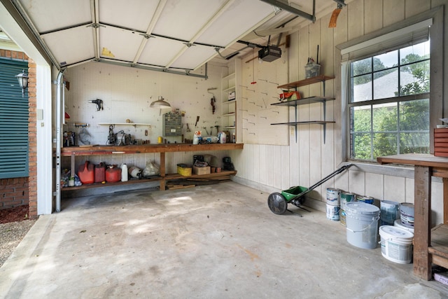 garage featuring a garage door opener and a workshop area