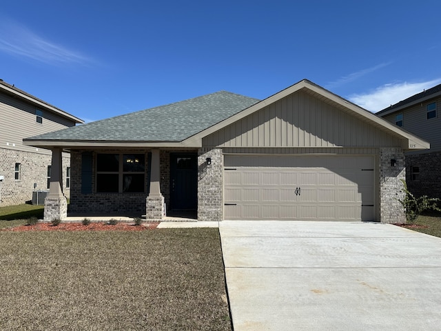 view of front of home with brick siding, roof with shingles, concrete driveway, central AC, and a garage