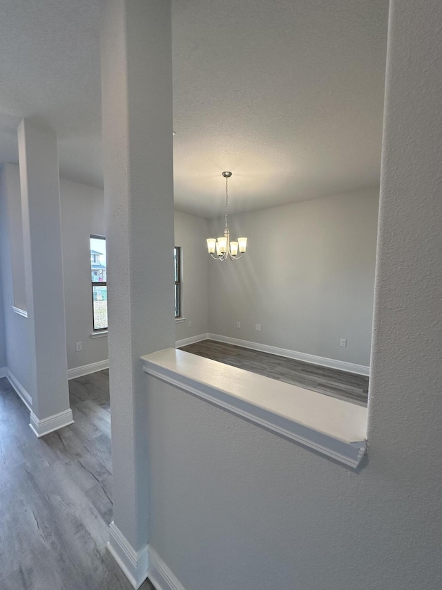 interior space with a chandelier and hardwood / wood-style flooring