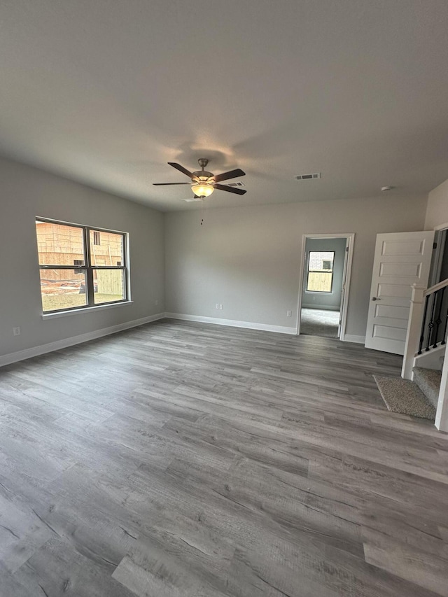 unfurnished living room with hardwood / wood-style flooring, plenty of natural light, and ceiling fan